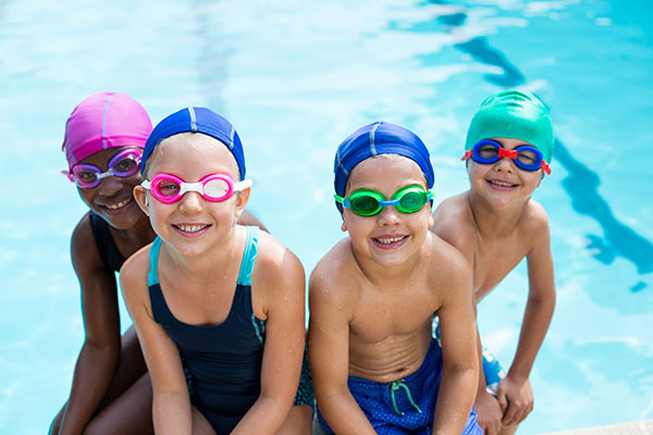 PIBALES-FreePik-portrait-little-swimmers-sitting-poolside-web